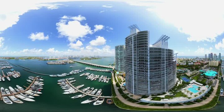 Aerial Miami Beach condos and marina by bridges and islands 360 8k VR footage