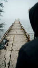 Fototapeta premium Serene Waterscape with Foggy Pier Leading to Calm Lake in the Morning