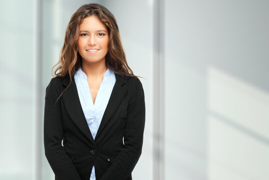 Confident young businesswoman smiling in modern office
