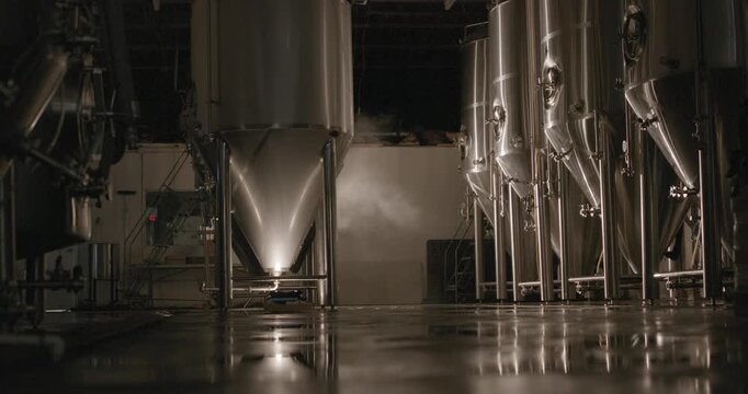 Modern craft brewery interior with stainless steel fermentation tanks and brewing equipment