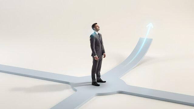 A businessman in a grey suit standing at a three-way intersection with a glowing blue arrow pointing upwards to indicate business growth