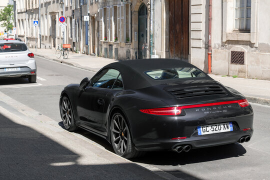 Nancy, France - July 9th 2026 : View on a black Porsche 991 Carrera 4S Cabriolet parked on a street.