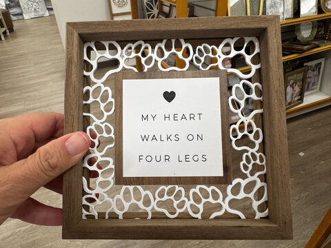 Hand holds a decorative sign - My Heart Walks on Four Legs home decor