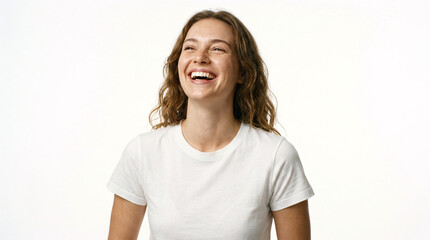 Fototapeta premium Cheerful young woman with curly brown hair laughing and looking up happily against a white background
