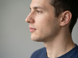 Fototapeta premium Handsome young man profile portrait, side view, thoughtful face
