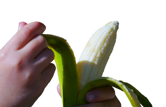 On a white background, a girl is holding a banana in her hand and wiping it with a banana peel.