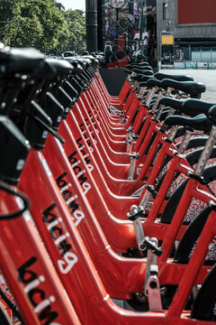 Row of red Bicing bike-share bicycles parked at station in Barcelona
