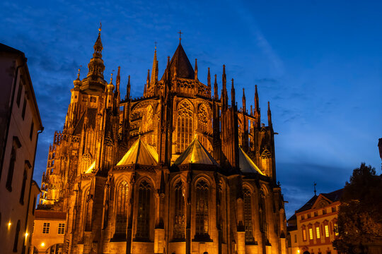 Saint Vitus Cathedral illuminating Prague Castle at twilight