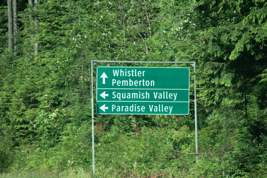 View of sign with directional arrows point to Whistler Pemberton, Squamish Valley and Paradise Valley on Sea to Sky Highway