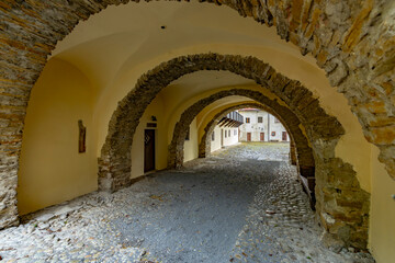 Fototapeta premium Archway tunnel leading to courtyard at Cerveny Klastor, Slovakia