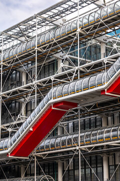 Paris, France - Dec 04, 2021: Architectural facade of the Centre Pompidou exterior glass tubes and red structural supports modern art museum design and iconic high-tech style