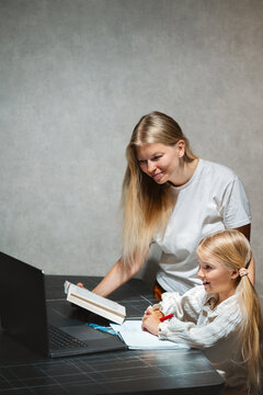 Parent helping child student with online learning using laptop and internet,  family mother tutor and daughter having fun homeschooling digital education