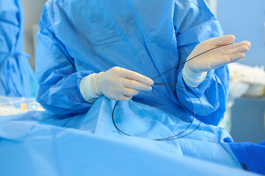 Vascular surgery. Prevention of blood clots. Vein surgery in a modern operating room. Surgeons' hands