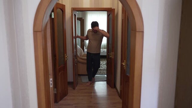 Man feels unwell, staggers down hallway, dizzy