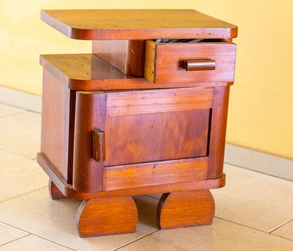 Vintage rose cedar wood nightstand featuring an open drawer, cabinet door, and rounded retro-style feet, showcasing mid-century handmade woodworking craftsmanship.