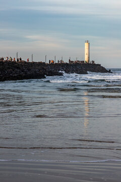 Barra de Torres Lighthouse at the Mampituba River Entrance with Fishermen on the Jetties