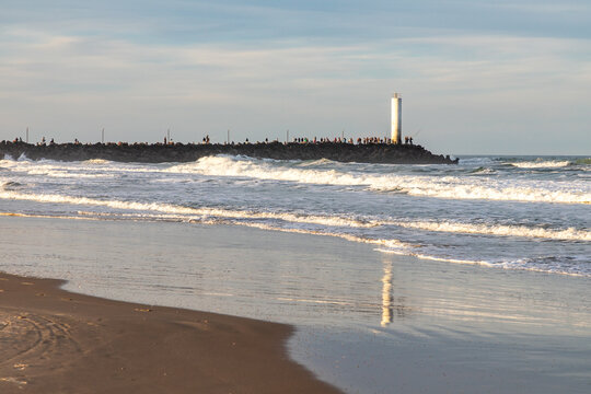 Barra de Torres Lighthouse at the Mampituba River Entrance with Fishermen on the Jetties