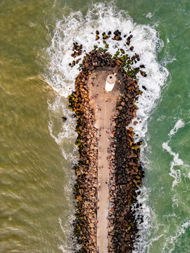 Top-Down Drone View of the Jetty with People Walking Between the Sea and the River in Torres, Brazil