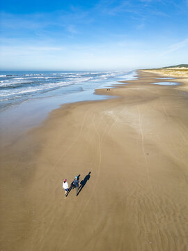 Couple Hiking Along the Beach with Panoramic Coastal View in Torres, Brazil