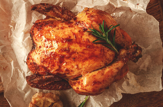 Fried chicken, on parchment paper, on a wooden board, top view, no people,