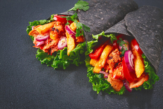 chicken shawarma in black lavash, on a black background,homemade, no people,