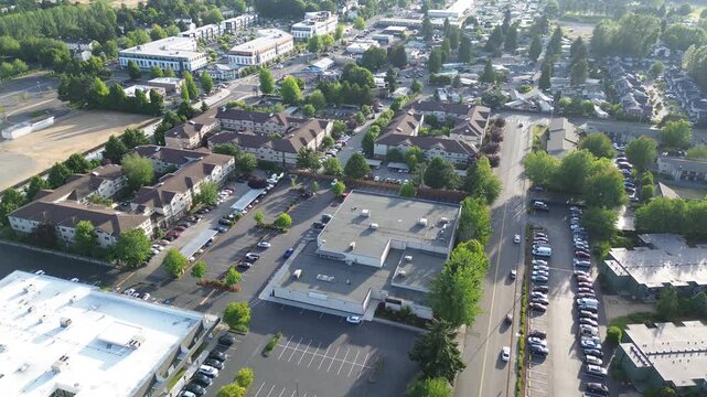 Suburban infrastructure layout apartment complexes sit near dense storage unit facilities in Kent. Tree lined streets and organized parking grids define the residential and commercial mix, WA