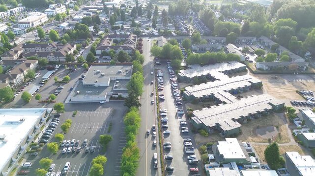 Kent industrial edge residential apartment clusters lie adjacent to massive storage facilities. Uniform rooftops create an intense grid pattern across the growing urban landscape WA, King County