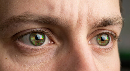 Naklejka premium Macro close up of human eyes with reflection of financial charts. Intense focus of trader analyzing data on betting exchange screen