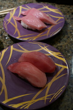 Fresh sushi on colorful plates in a Kaiten sushi restaurant in Japan