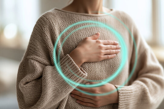  Mindful deep breathing exercise concept showing a person's hands on chest and belly with a glowing cyan energy circle overlay, mental health and anxiety relief.
