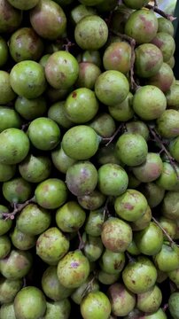 Close up of fresh green mamoncillos fruit arranged in a tropical bunch, highlighting ripe organic food textures for natural nutrition and healthy diet concepts