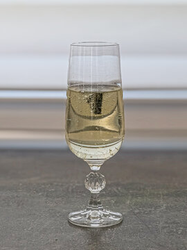Chocolate triangle floating near surface of sparkling champagne glass