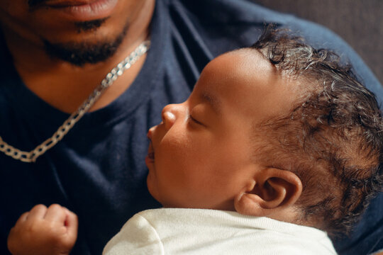 Sleeping infant resting comfortably on parent's chest