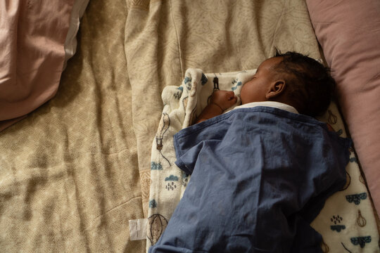 Little baby sleeping peacefully on soft bed