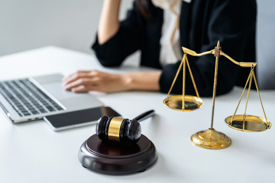Legal professional considers justice compliance using scales gav