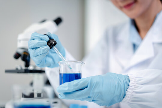 Scientist research professional transferring blue liquid with dr