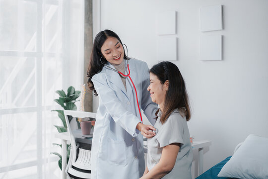 Asian Doctor Checking Older Patient with Stethoscope Healthcare