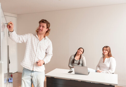 Adult education session with teacher and students