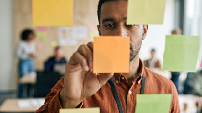 Diverse team workshop with sticky notes in modern office