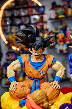 Ambato, Ecuador - October 28, 2025: Collectible action figure of anime character Son Goku sitting on yellow Flying Nimbus cloud from Dragon Ball series, at pop culture store showcase in shop setting