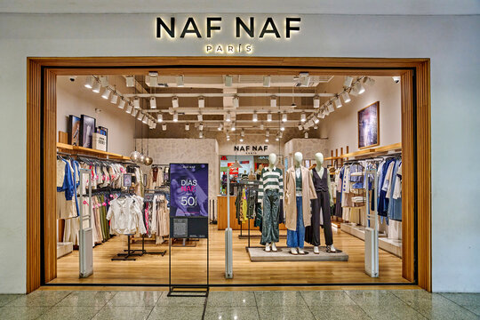 Ambato, Ecuador - October 28, 2025: NAF NAF Paris clothing store entrance showcasing various apparel and mannequins in a well-lit retail environment
