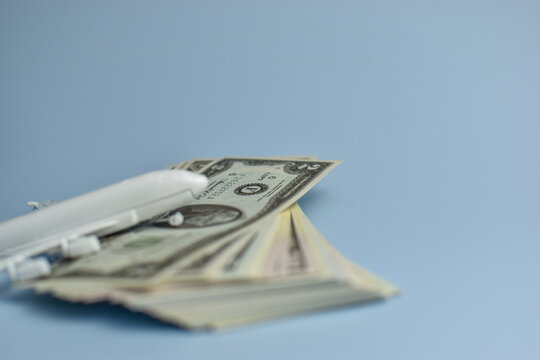 White airplane sits atop US dollar bills