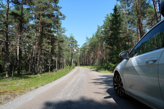 Car Driving Along a Forest Path in &Ouml;rens Nature Reserve on Tor&ouml;, Sweden on a Sunny Summer Day