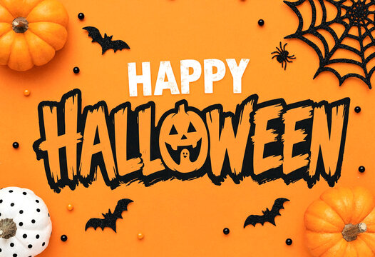 Colorful halloween greeting card with pumpkins bats and spiders on bright orange background