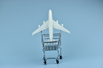 Mini airplane rests atop shopping cart © Nazir