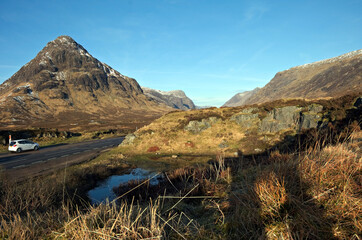 Stob Dearg, the principal peak of Buachaille Etive Mor and other Glencoe mountains in spring sunshine. Seen from Rannoch Moor just off the A82 road. Glencoe, Lochaber, Scottish Highlends. © David