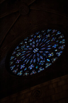 Epic gothic rose window stained glass ancient cathedral church interior vertical view.
