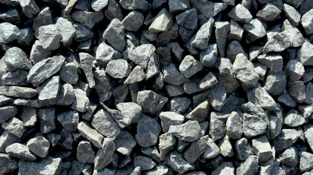 Closeup view of rough gray stones in various shapes and sizes forming a textured surface