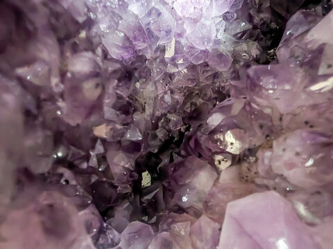 Exploring the Shimmering Interior of a Natural Amethyst Crystal Geode with Sparkling Purple Mineral Texture