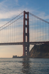 Obraz premium Long and colorful span of north tower of Golden Gate Bridge stretches across the waters of the San Francisco Bay